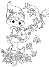 Мальчик раскрашивает листья